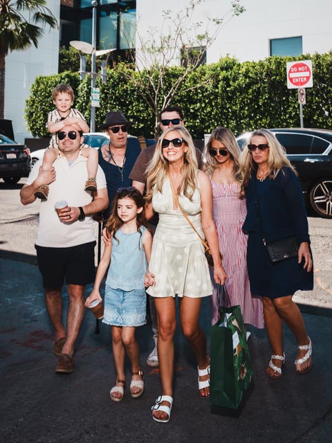 Stylish family walking on Rodeo Drive in Beverly Hills, candid luxury family portrait captured by Johnny Hann Photo