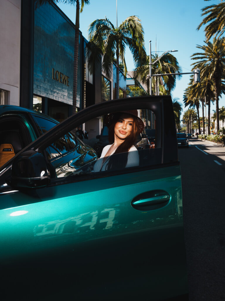 A stylish woman gets into the car in front of House of Dior on Rodeo Drive, Beverly Hills  