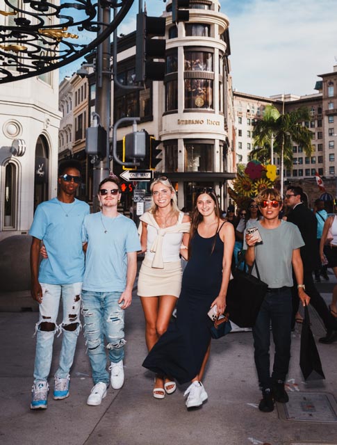 Group of friends posing on Rodeo Drive in Beverly Hills near Stefano Ricci store
