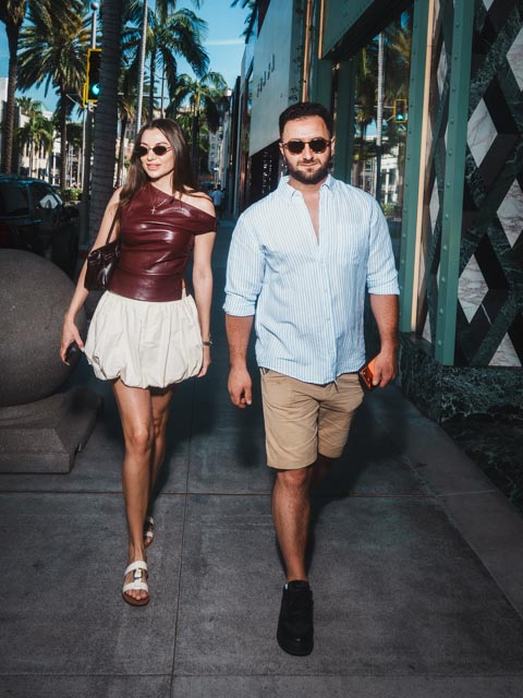 Stylish couple walking on Rodeo Drive Beverly Hills captured in luxury editorial portrait style with natural movement