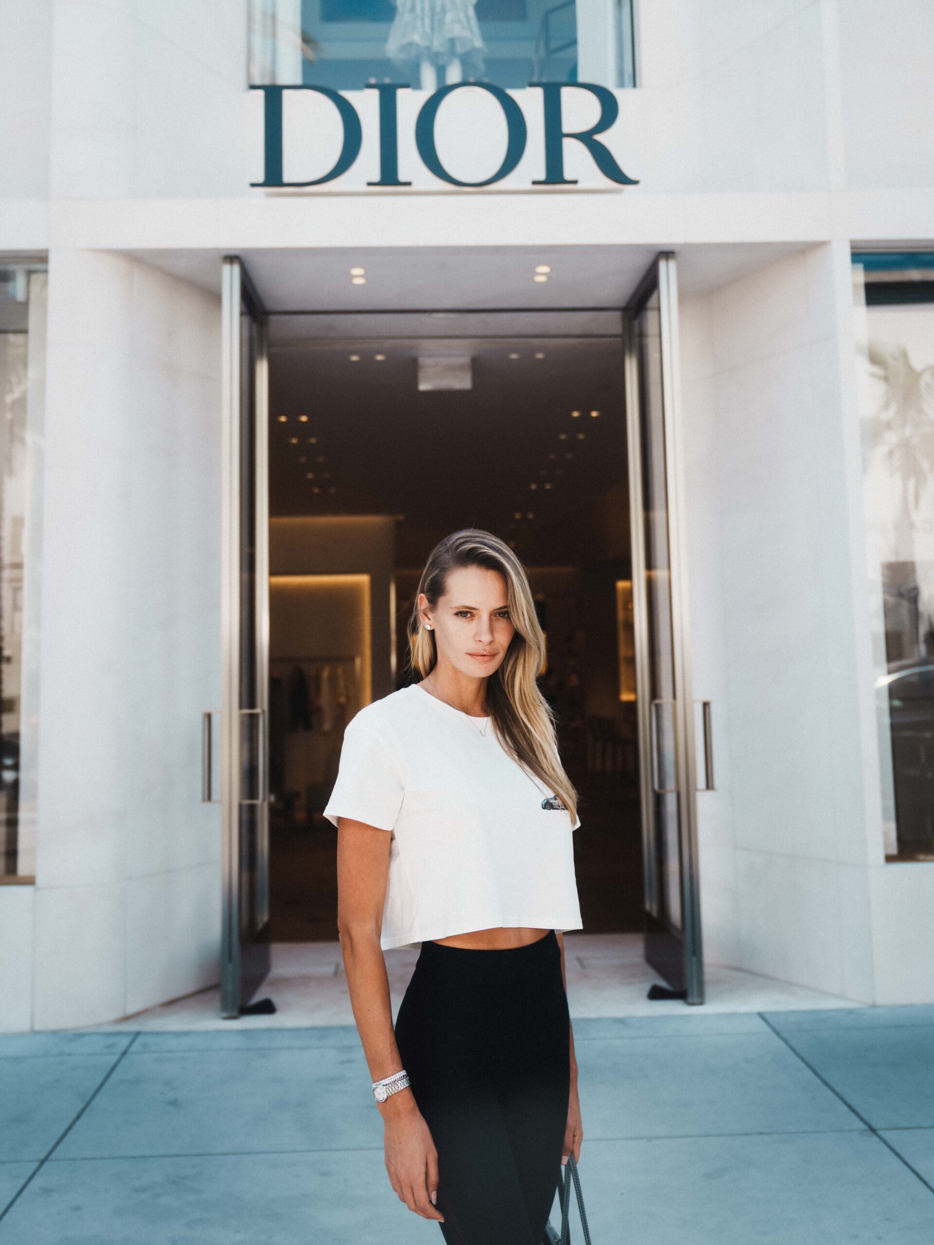 Evelyn Rose IMG model posing in front of Dior storefront on Rodeo Drive Beverly Hills
