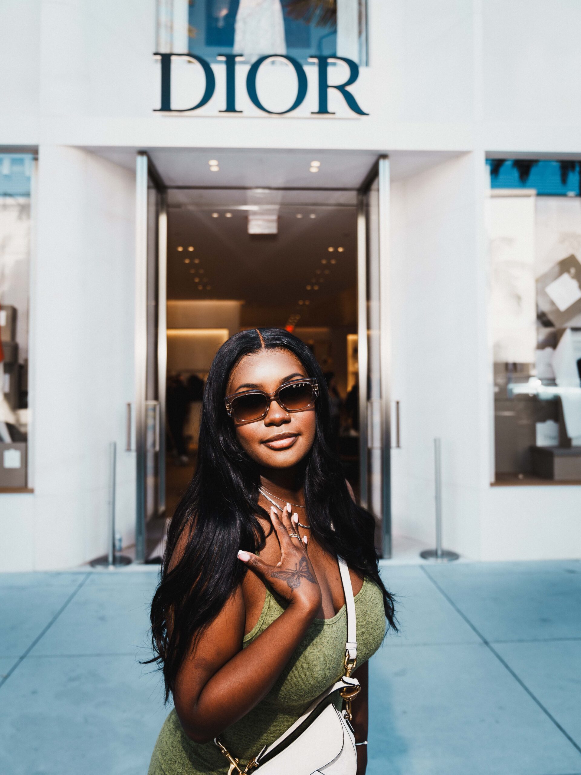 Portrait of woman wearing sunglasses in front of Dior Rodeo Drive Beverly Hills